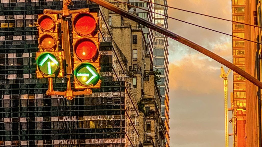 A traffic signal showing two green arrows — an unambiguous instruction on which way to move